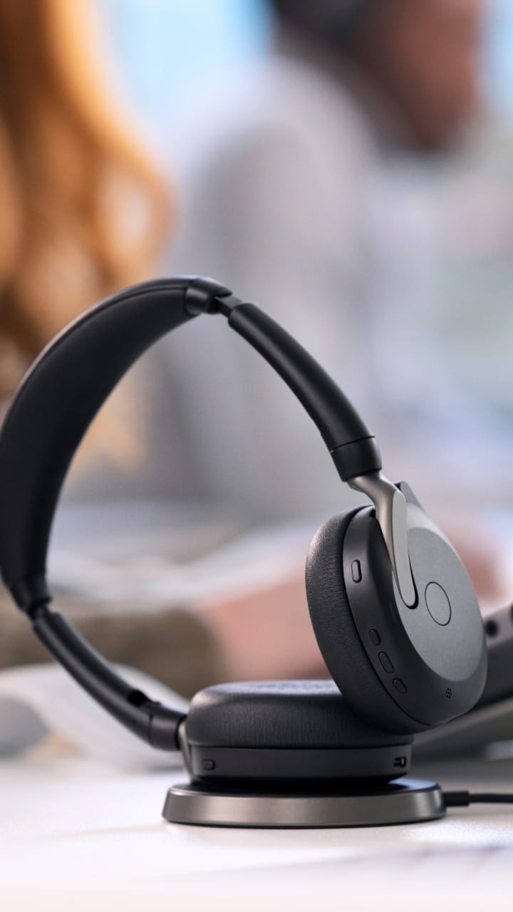 Jabra Evolve2 65 Flex headset on stylish charging station for hybrid workplaces