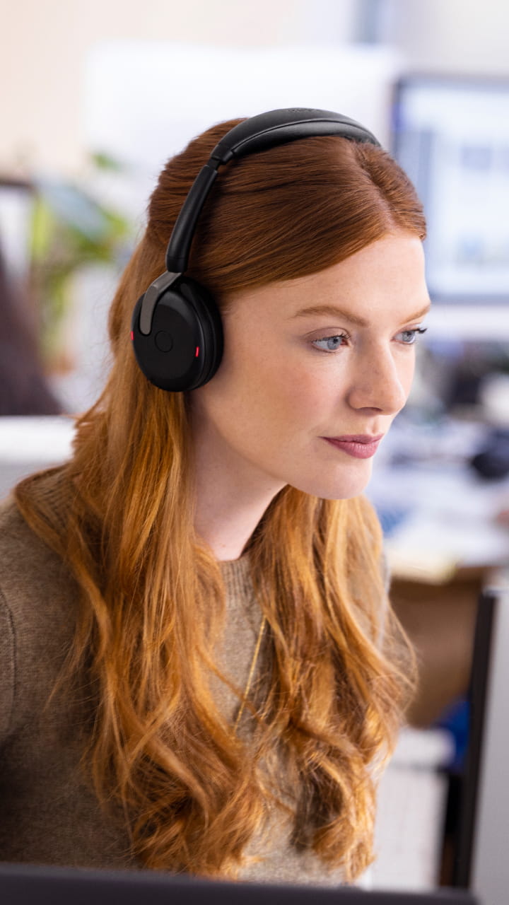 Woman wearing Jabra Evolve2 headset while working in the office – ideal for concentrated conference calls