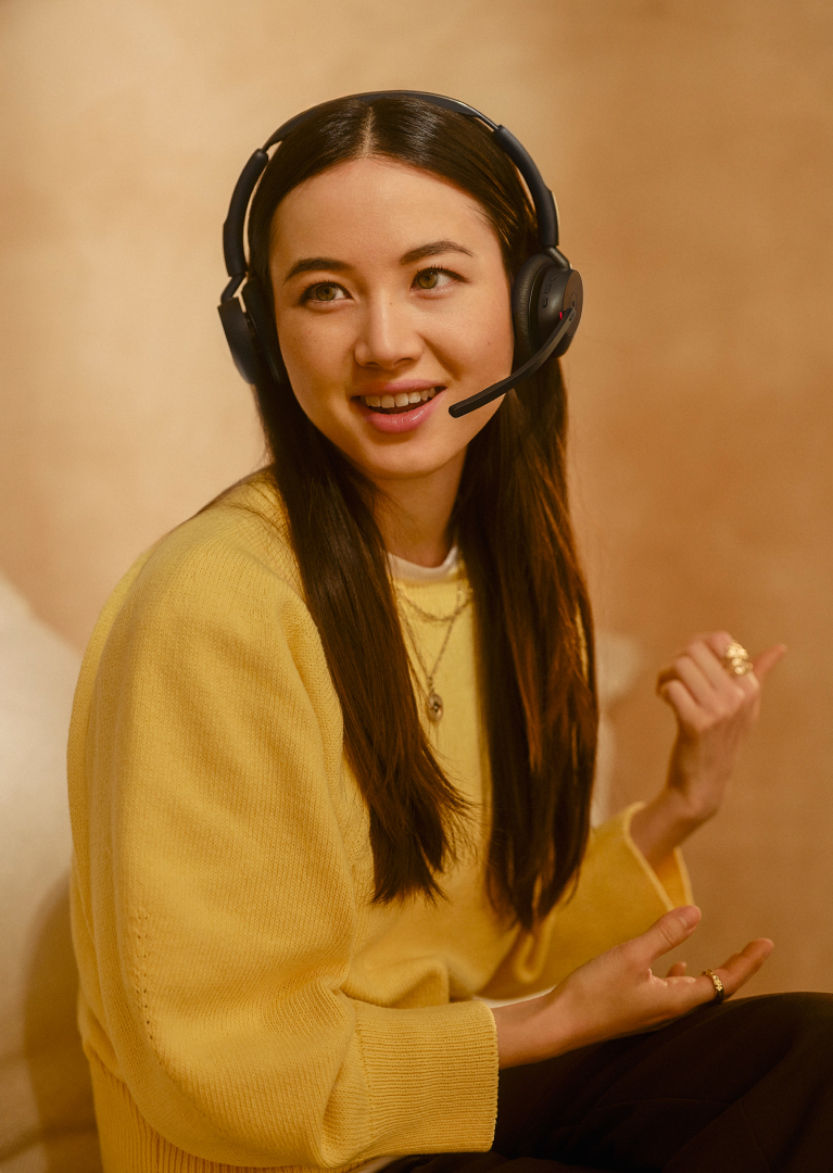 Person in yellow sweater wearing Jabra Evolve3 45 headset
