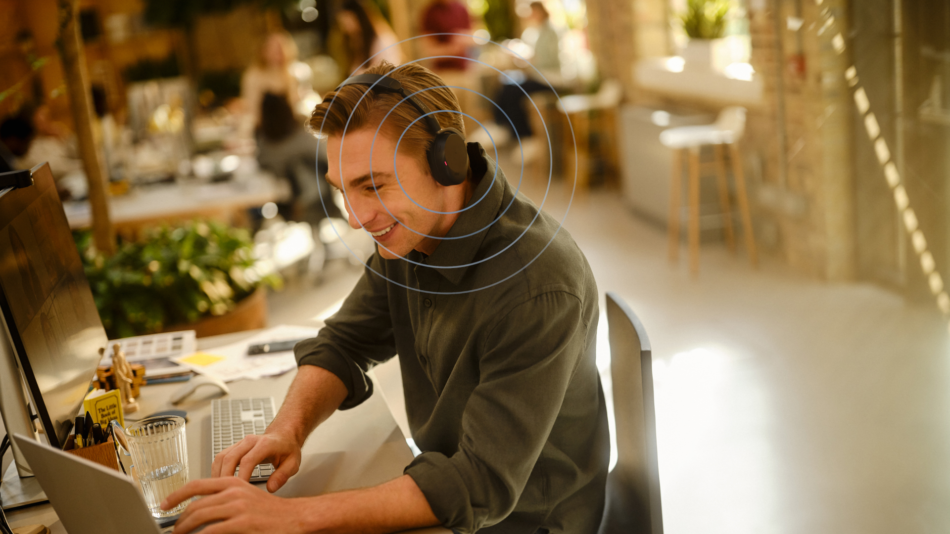 Person wearing Jabra Evolve3 65 Flex headset while working at a desk